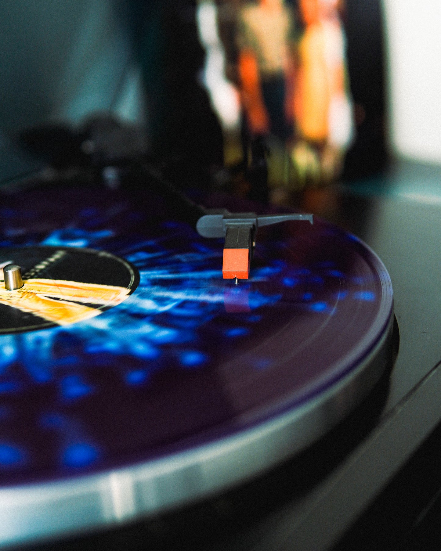 Turntable with a vinyl record and needle on a dark surface